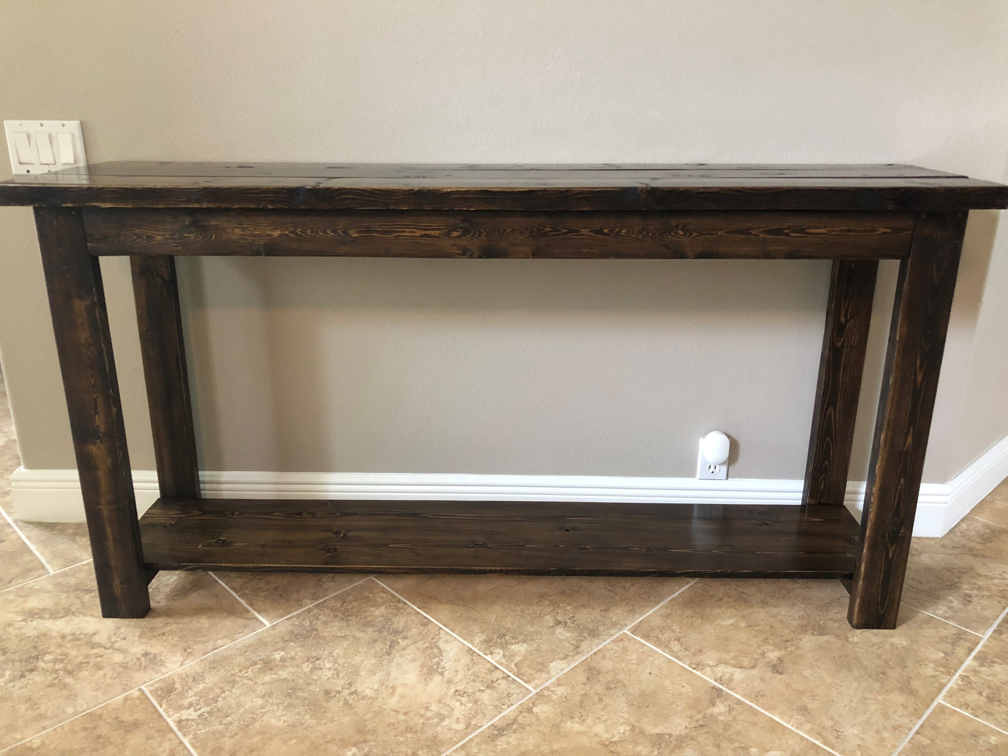 Custom solid wood entry table, sanded, stained in a dark walnut to give it a rustic finished look!.