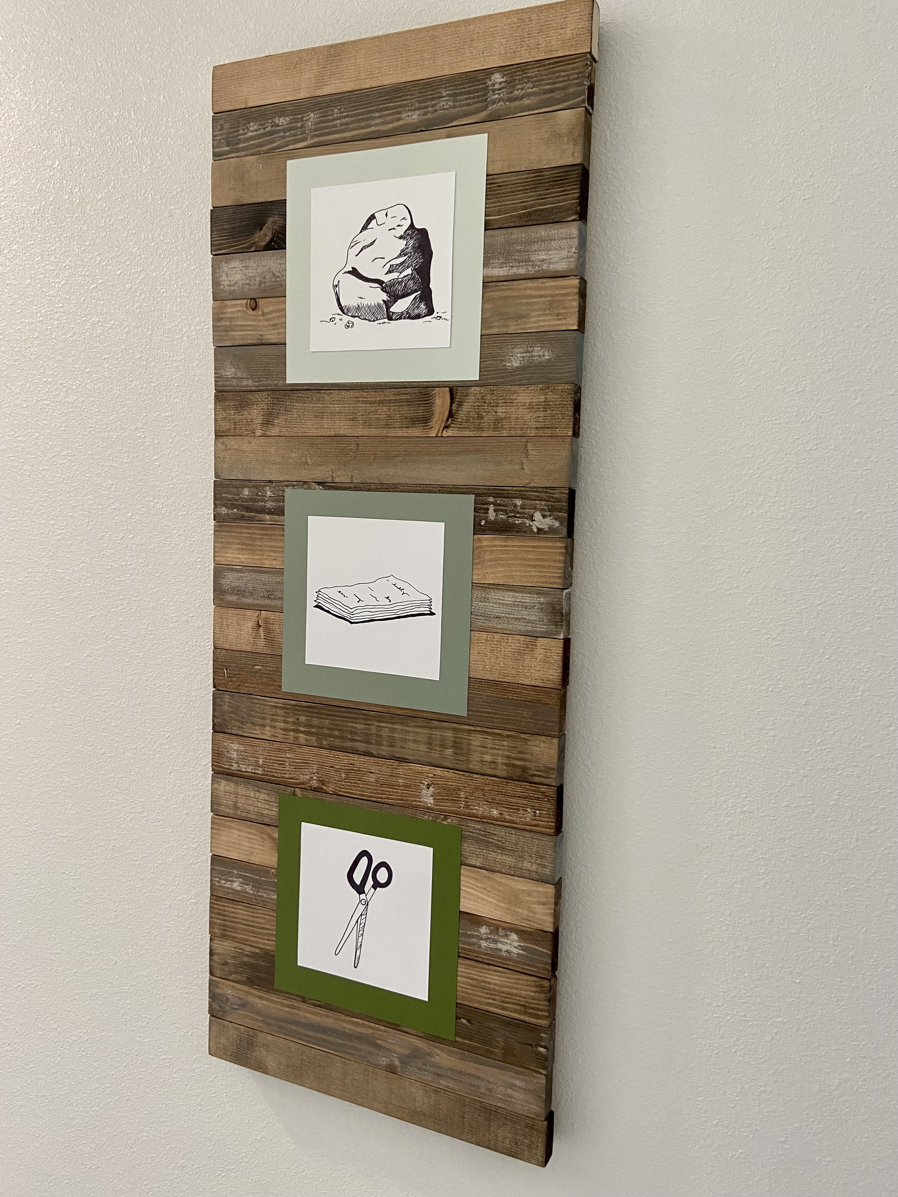 Rock, Paper, Scissors - 
		Hand drawn pictures were mounted to a custom built wood frame.